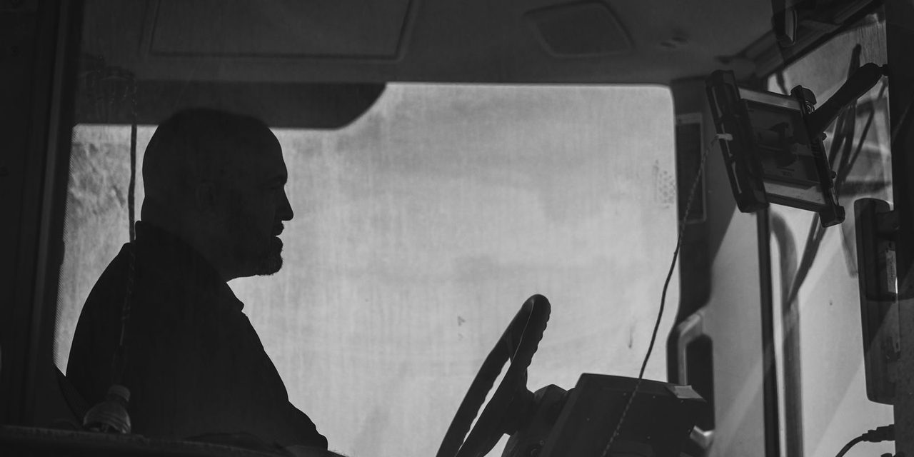 Chauffeur poids lourd au volant d'un camion de transport routier sur une route de Nouvelle-Calédonie