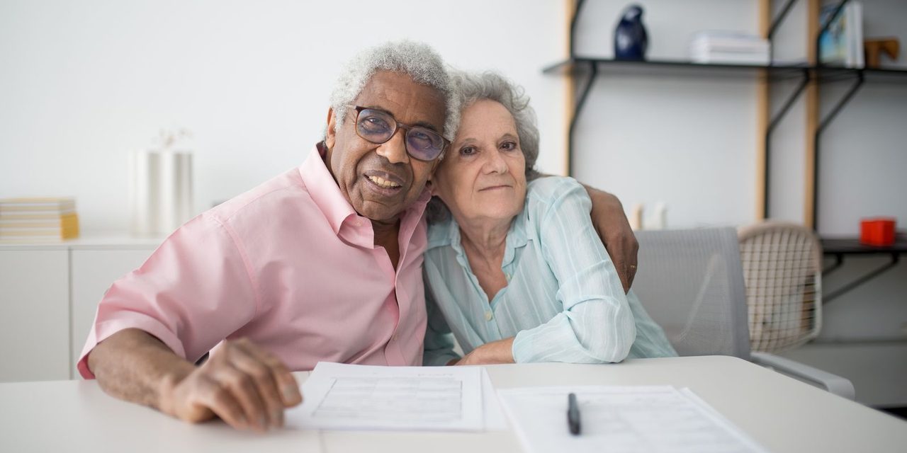 Un couple de seniors calédoniens examine ses documents de préparation à la retraite à domicile